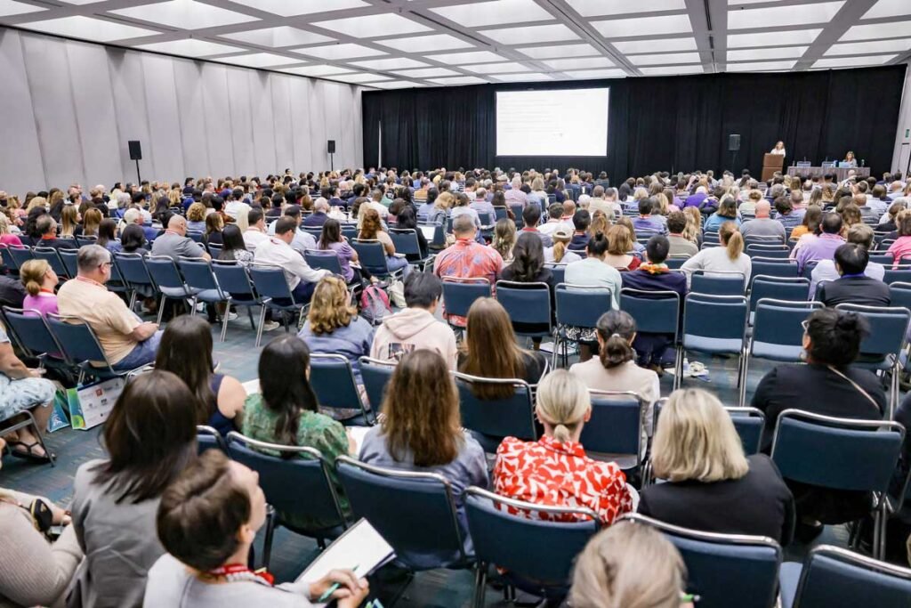 Photo of people in a conference room watching a speaker